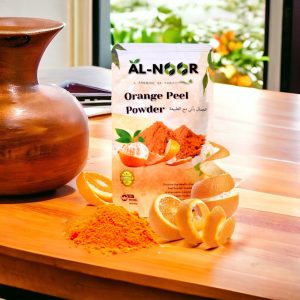 Al-Noor Orange Peel Powder packet on a wooden table with fresh orange slices, peels, and powder, alongside a clay pot and a blurred garden background.
